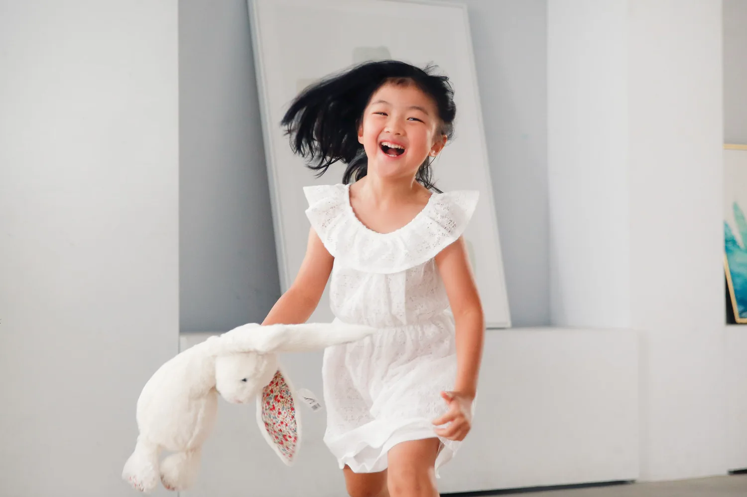 Angela and Andrew with their two daughters during an indoor family session in Singapore