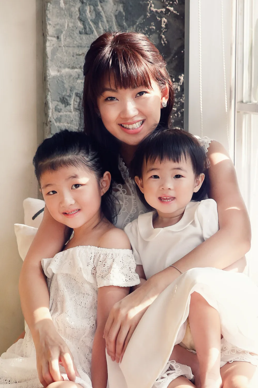 Family of four relaxing together during an indoor photoshoot in Singapore