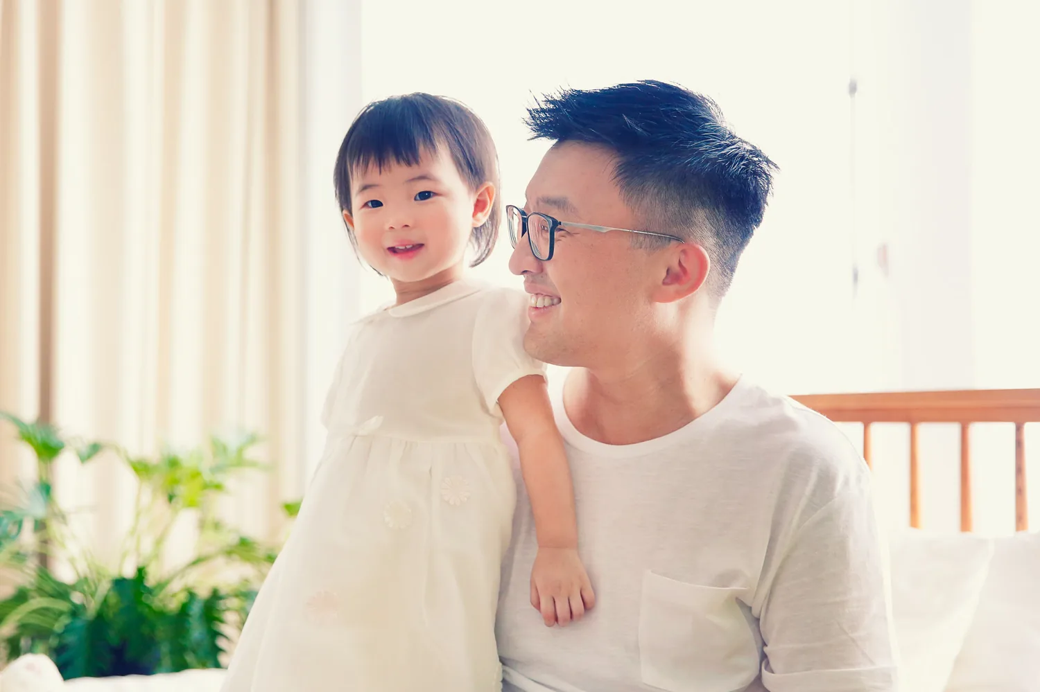 Angela and Andrew with their daughters in a bright Singapore home session