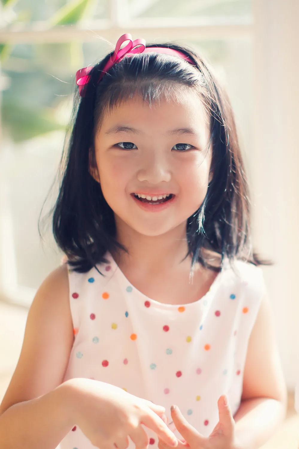 Sweet younger-sister moment from an indoor family session in Singapore