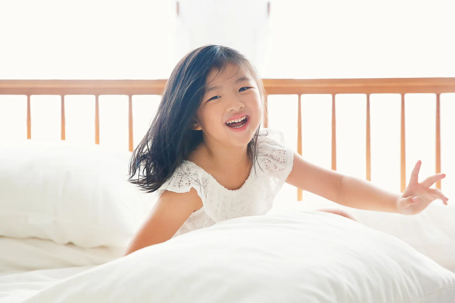Candid indoor family portrait with Angela, Andrew and their daughters at home in Singapore