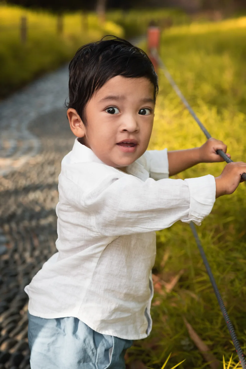 Jamie carrying Gabriel and Xander during the outdoor family session