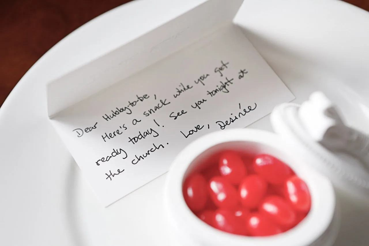 Handwritten note from Desirée on a white plate beside a bowl of red candy for Derek while he gets ready.