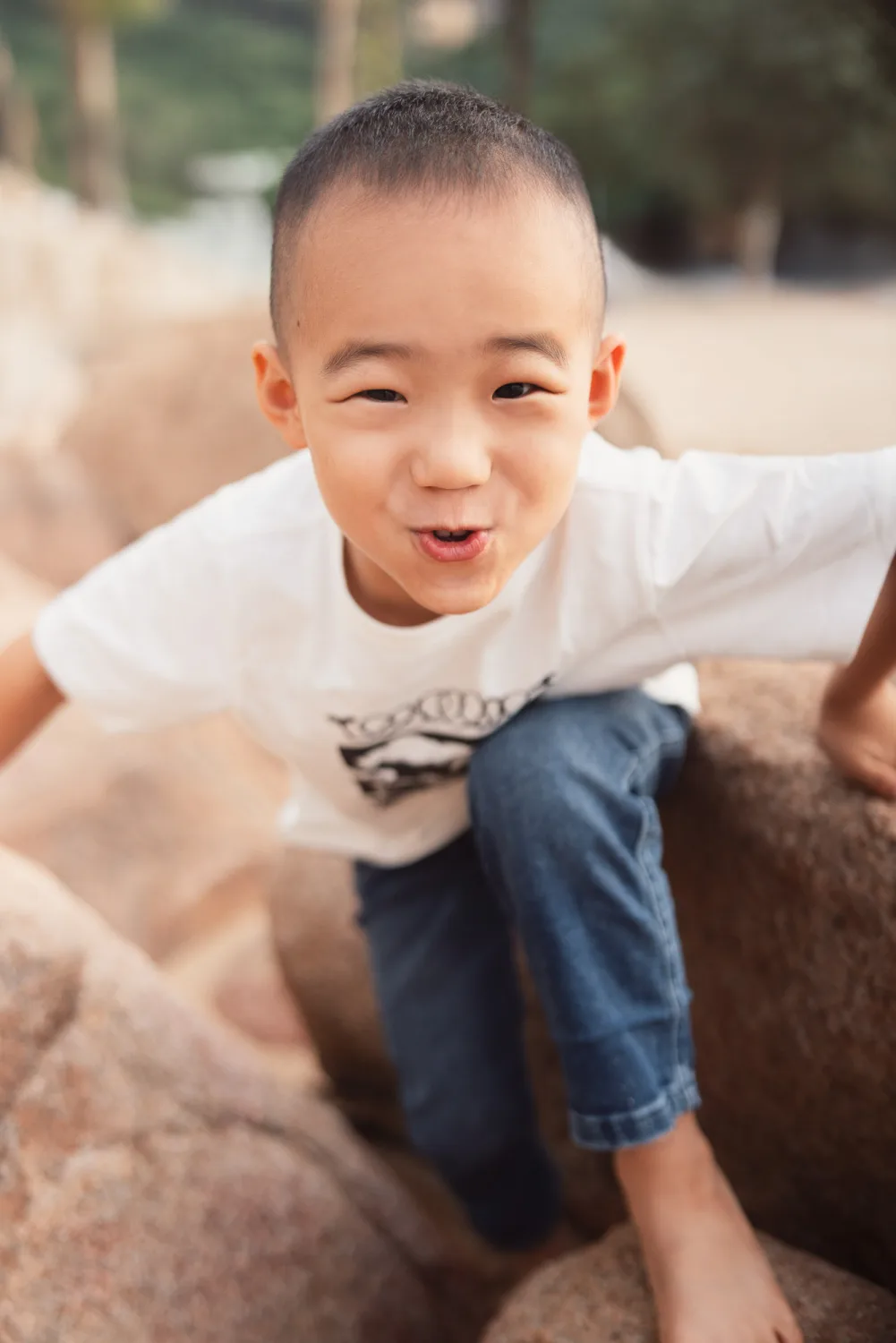 Nathan climbing across the rocks at the beach