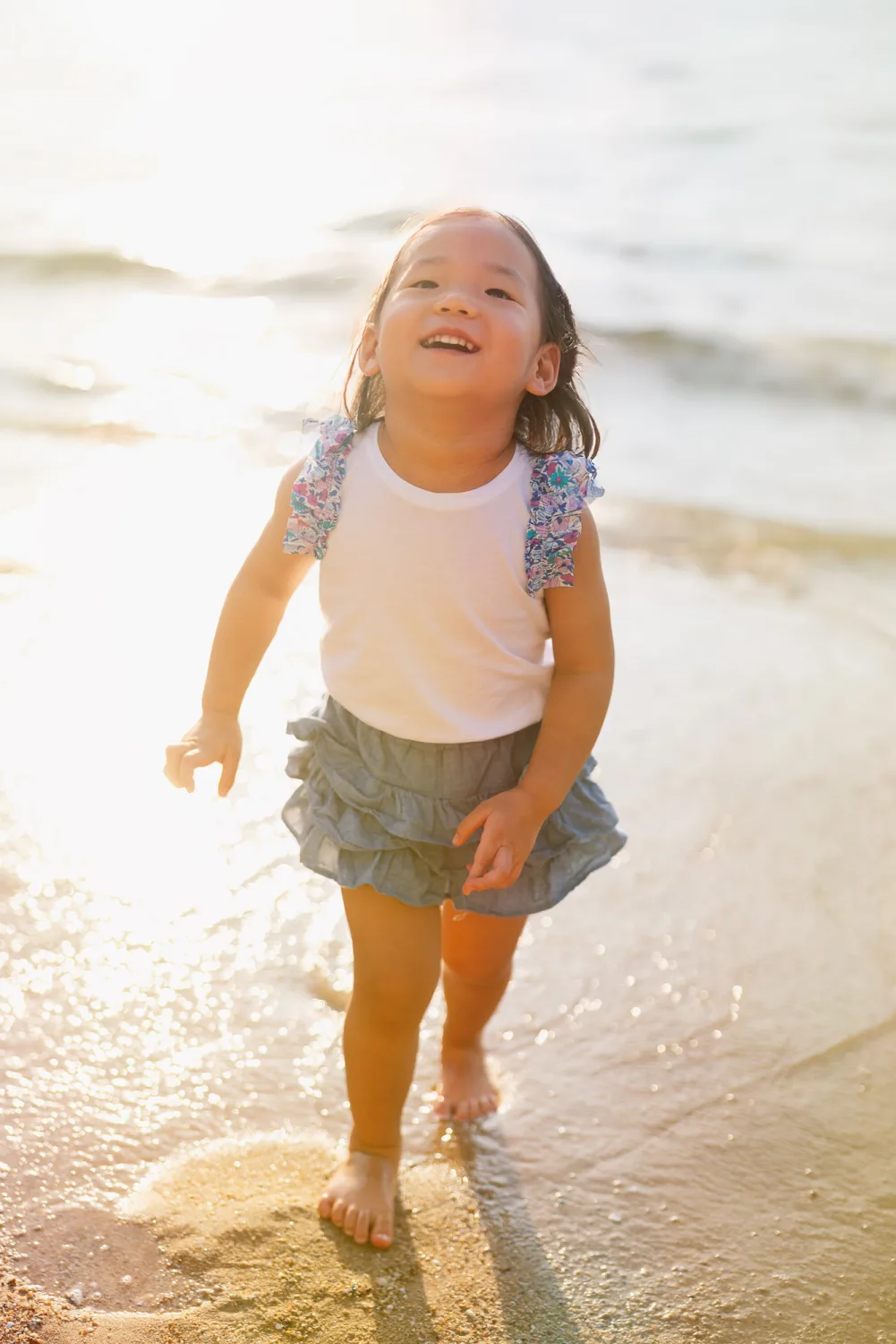 Amelia laughing as she walked along the shoreline