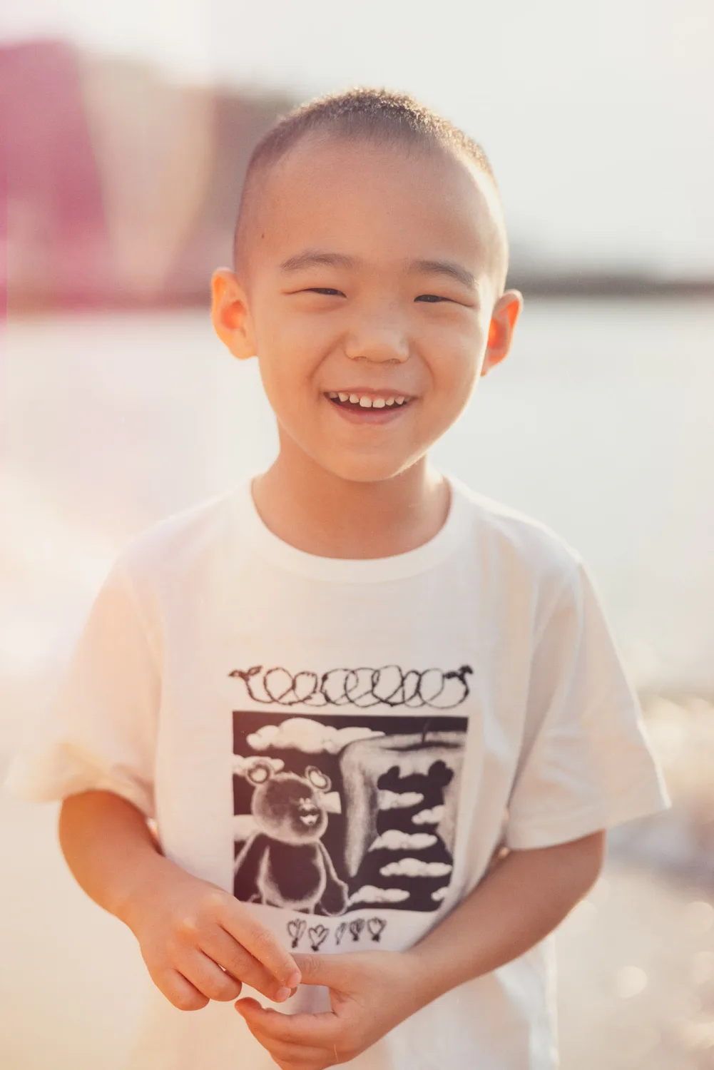 Nathan grinning in the sun during the beach session