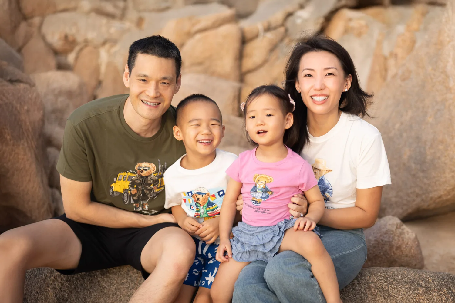Chelsea, Andrew, Nathan and Amelia together in matching tops on the rocks