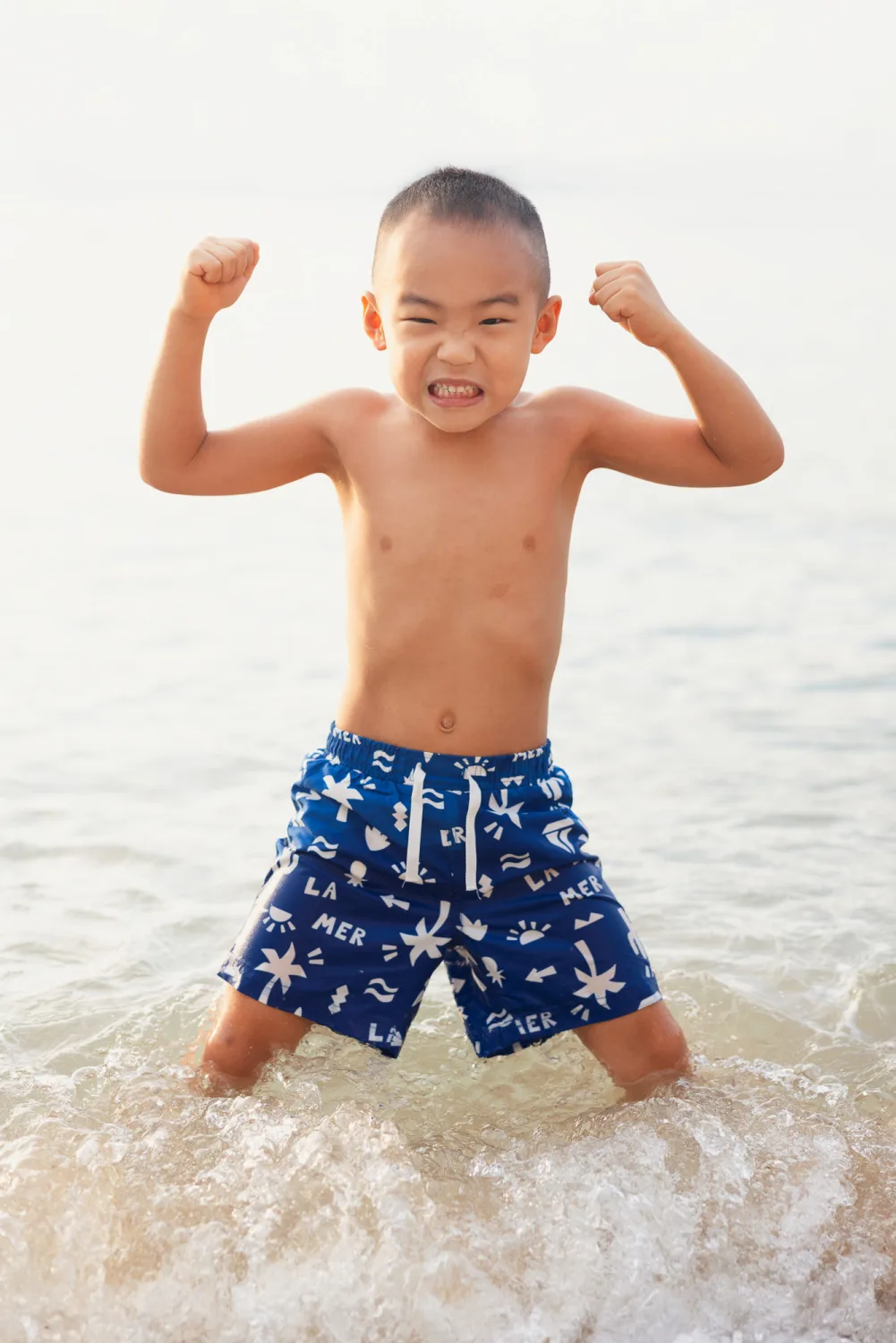 Nathan flexing in the water during the beach family session