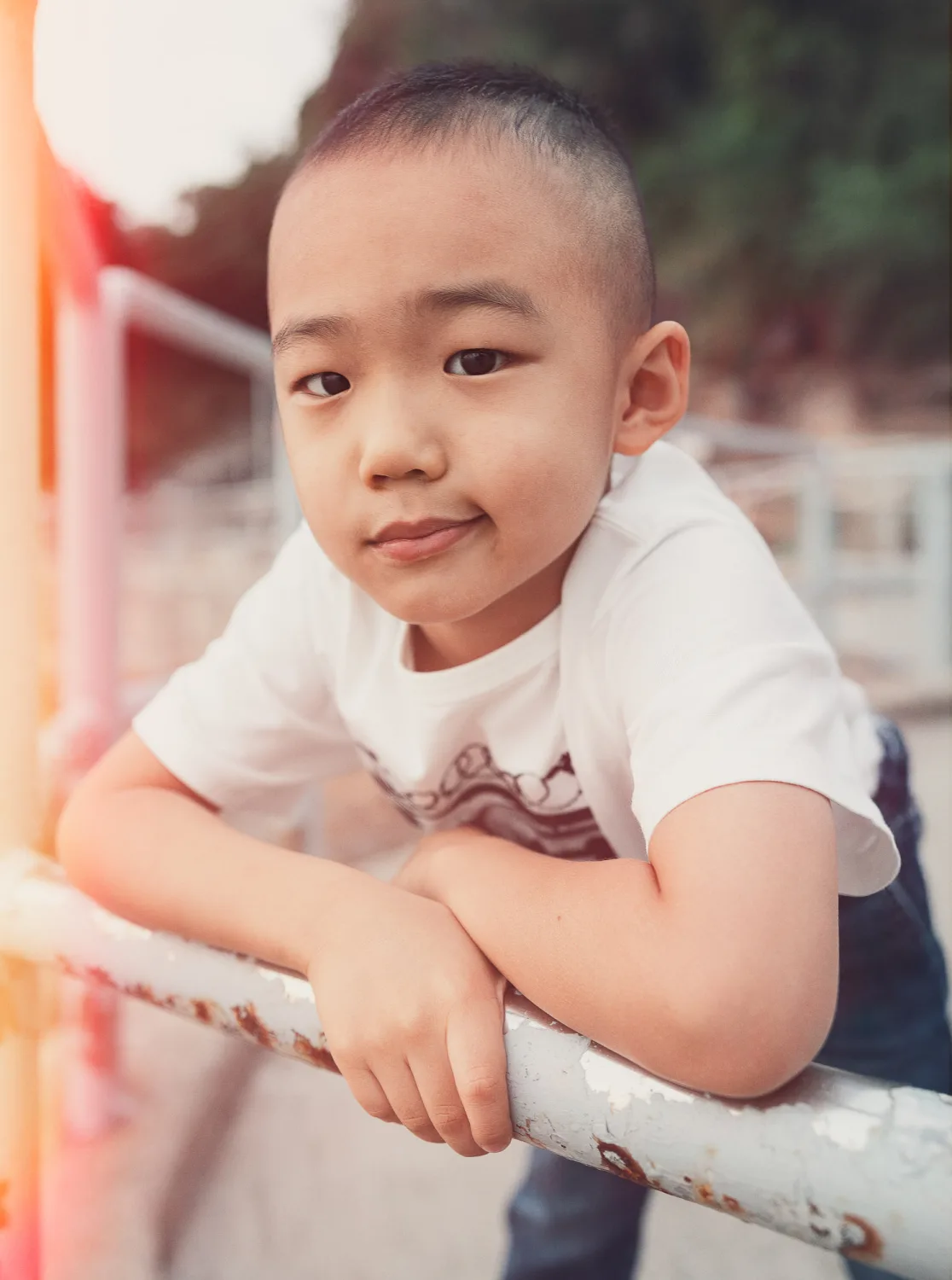 Nathan leaning on a rail during the beach session