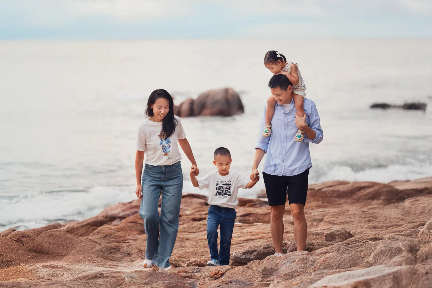 Chelsea and Andrew with Nathan and Amelia walking together along the rocks