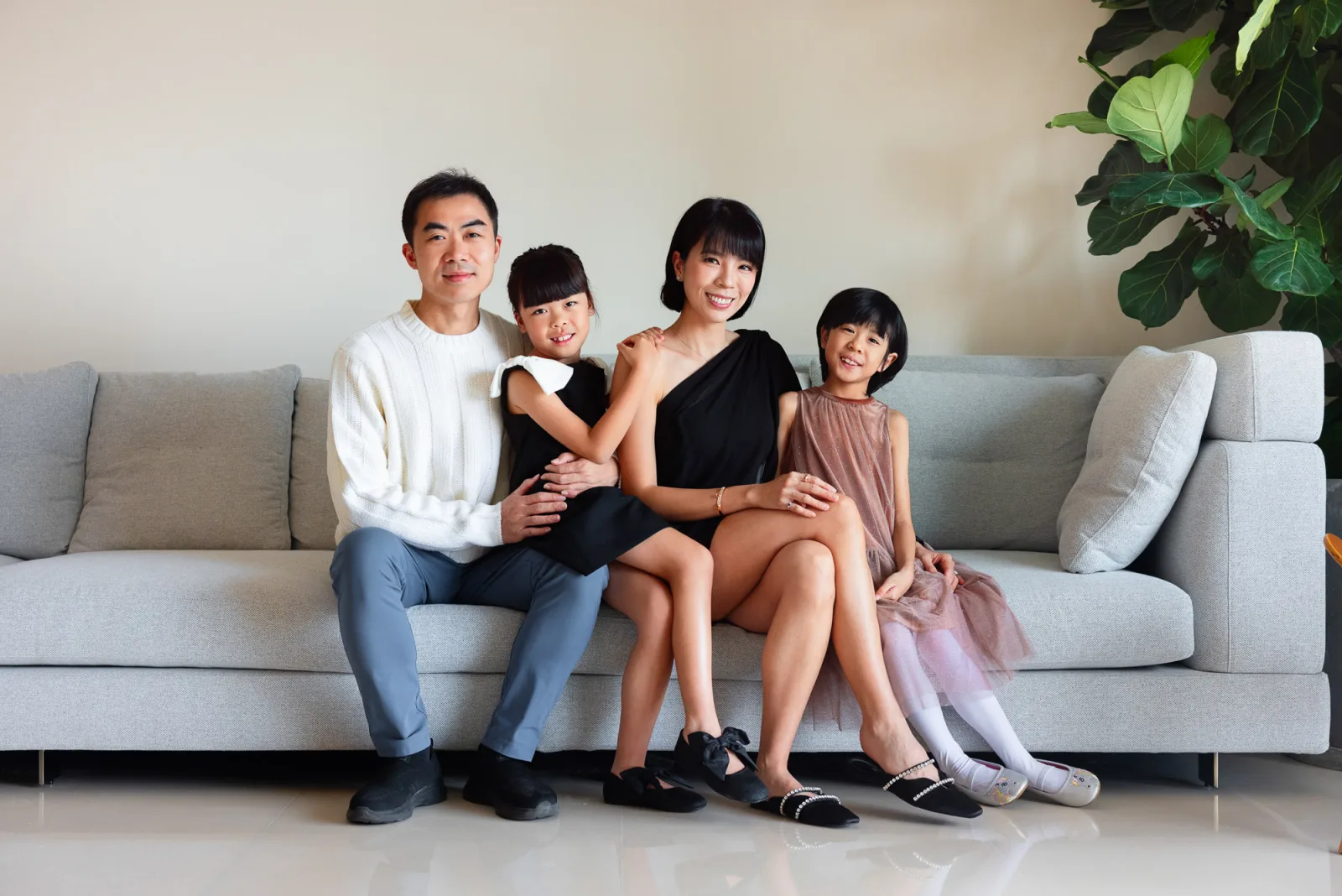 Family portrait in elegant clothing during indoor photography session in Singapore