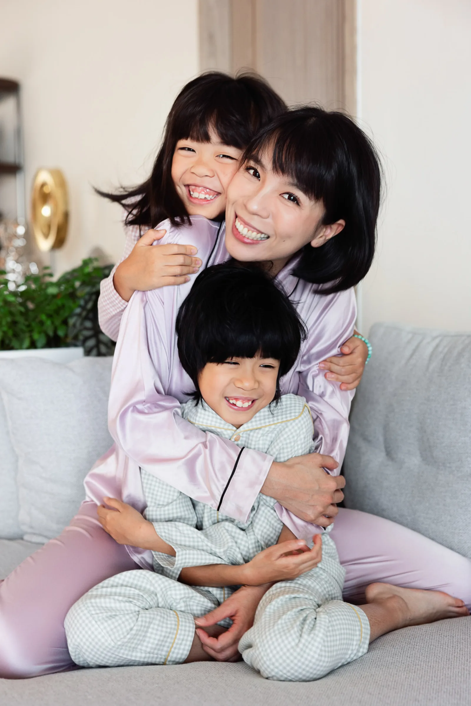 Ray and daughters mid-pillow fight with Coco laughing in the background