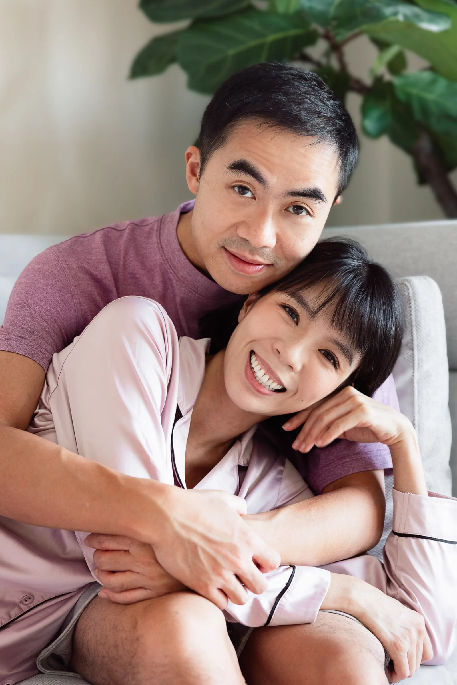 Candid laughter during pyjama pillow fight family session in Singapore