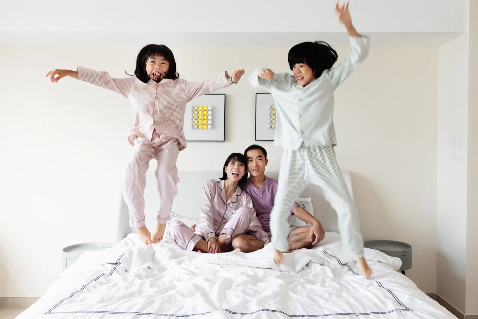 Parents and daughters in a relaxed family moment on the bed