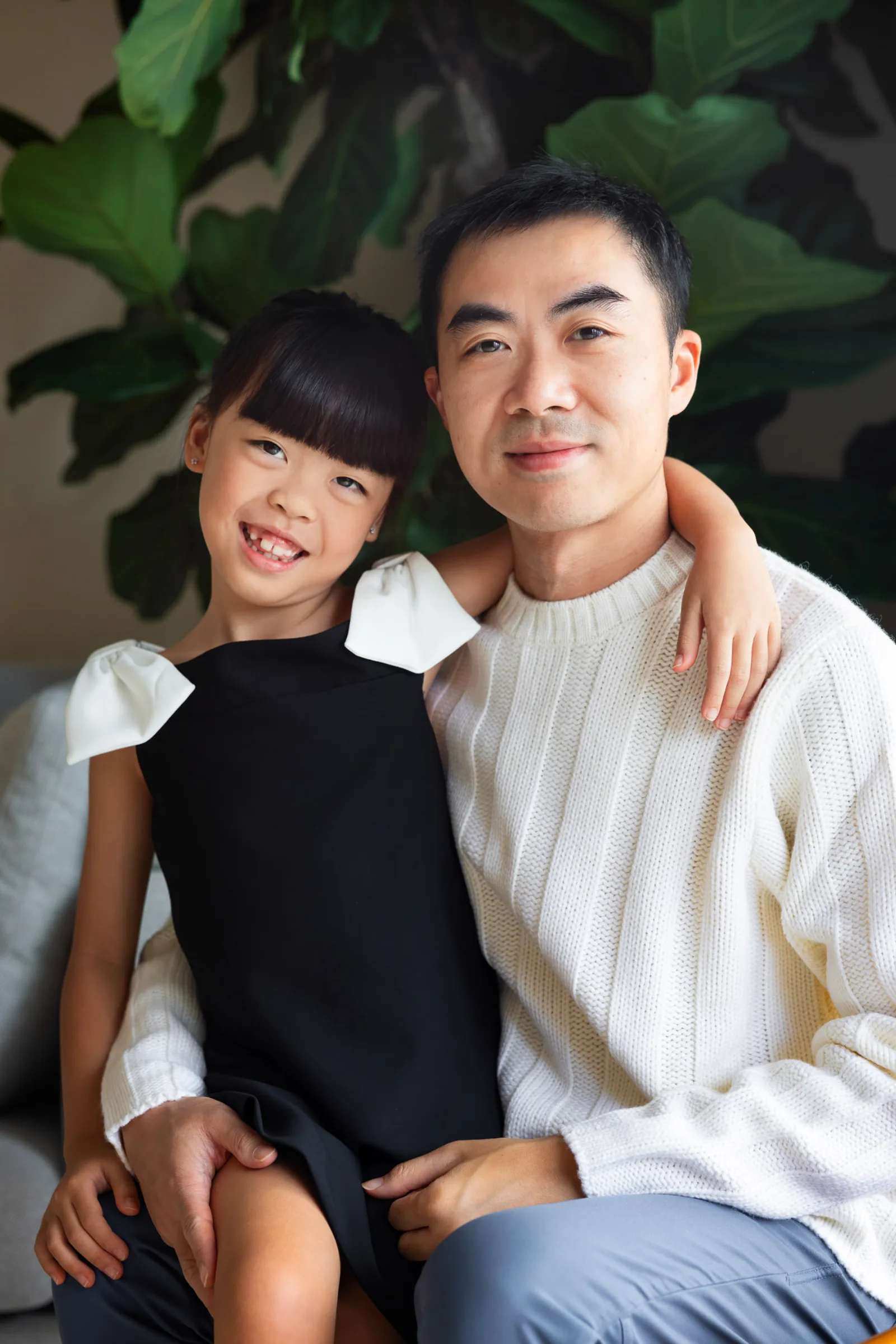 Coco and Ray posing together during dressy indoor family photography session