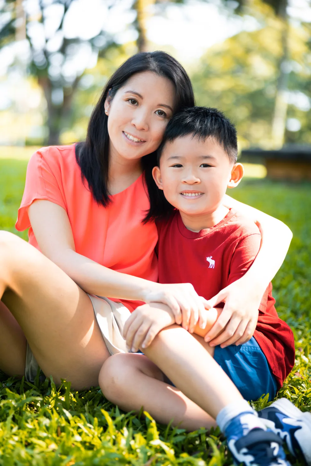 One of the boys in the leaves during the Fort Canning family session