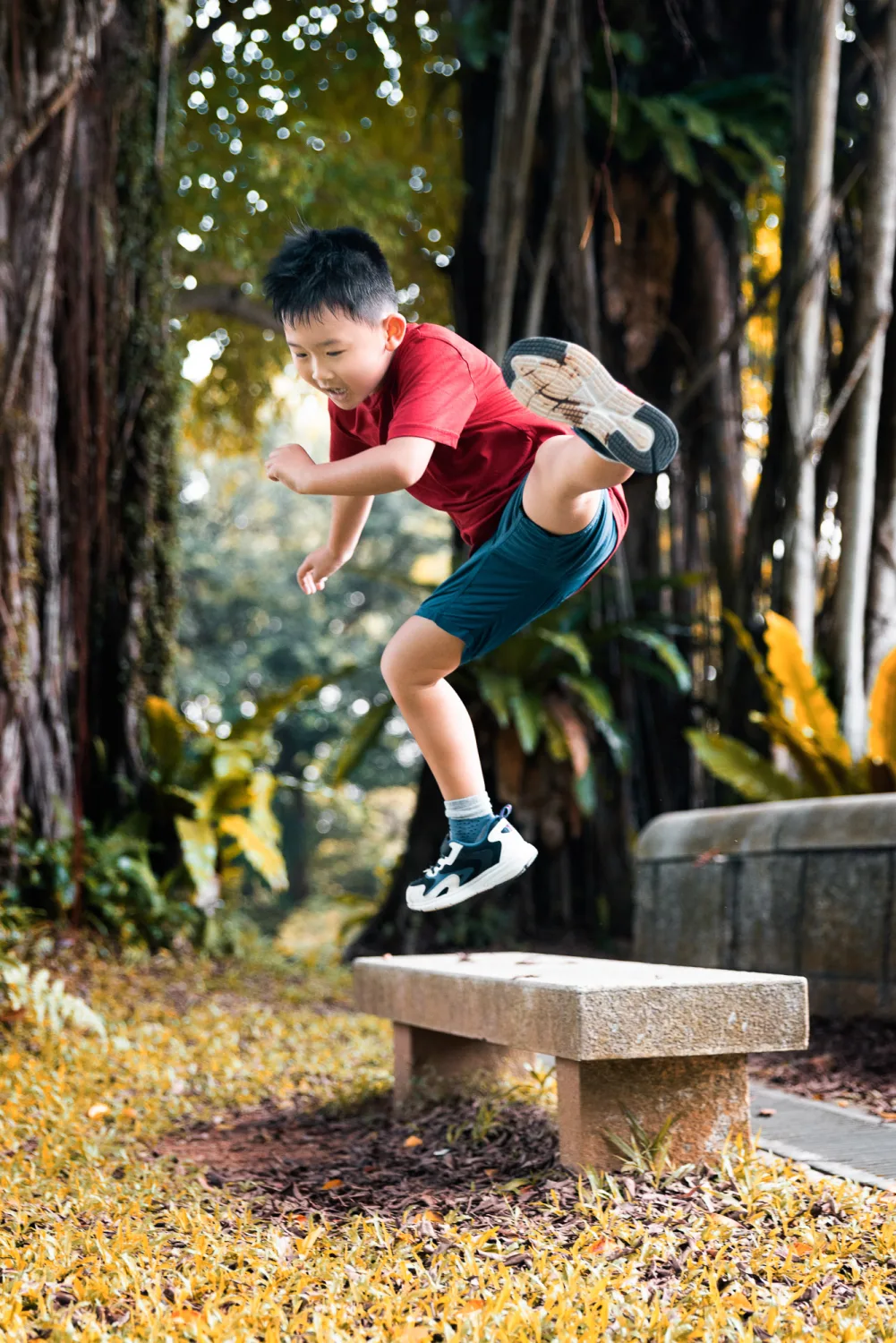 Kevin with Tristan on his shoulders among the trees at Fort Canning