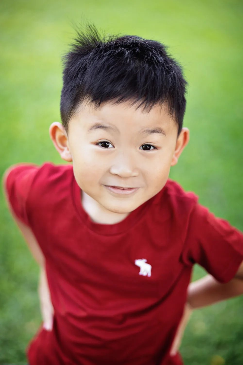 The family framed by Fort Canning’s trees during an outdoor family session in Singapore