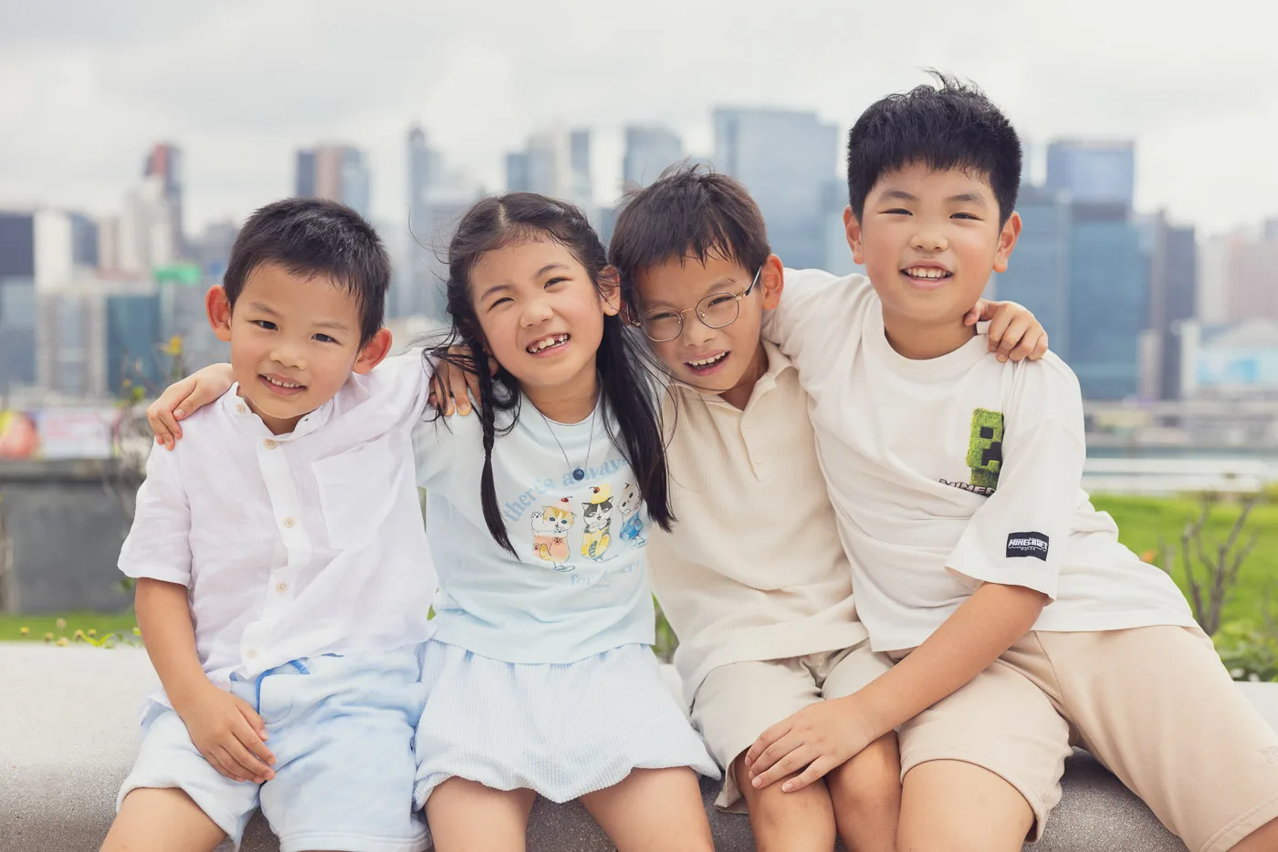 Kids laughing together during a waterfront family session in Hong Kong
