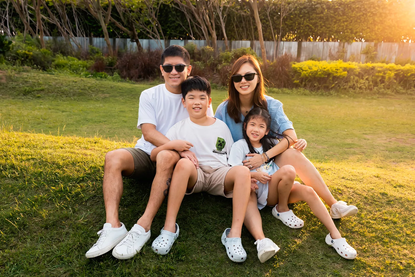 Xenia, Lok, Lachlan and Leila sitting together in golden light in Hong Kong