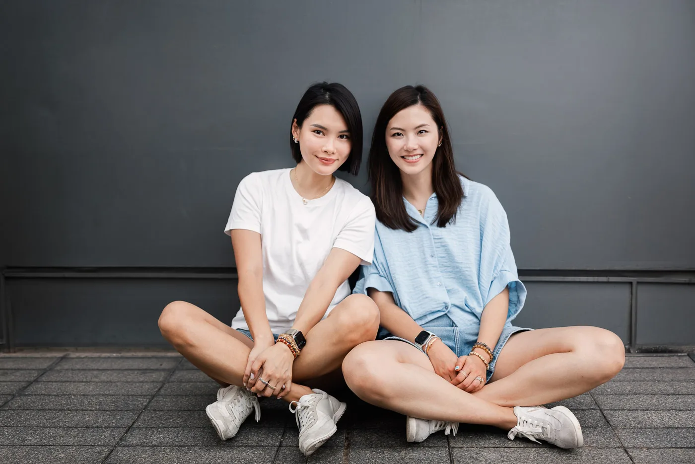 The children sitting together during a Hong Kong waterfront family session