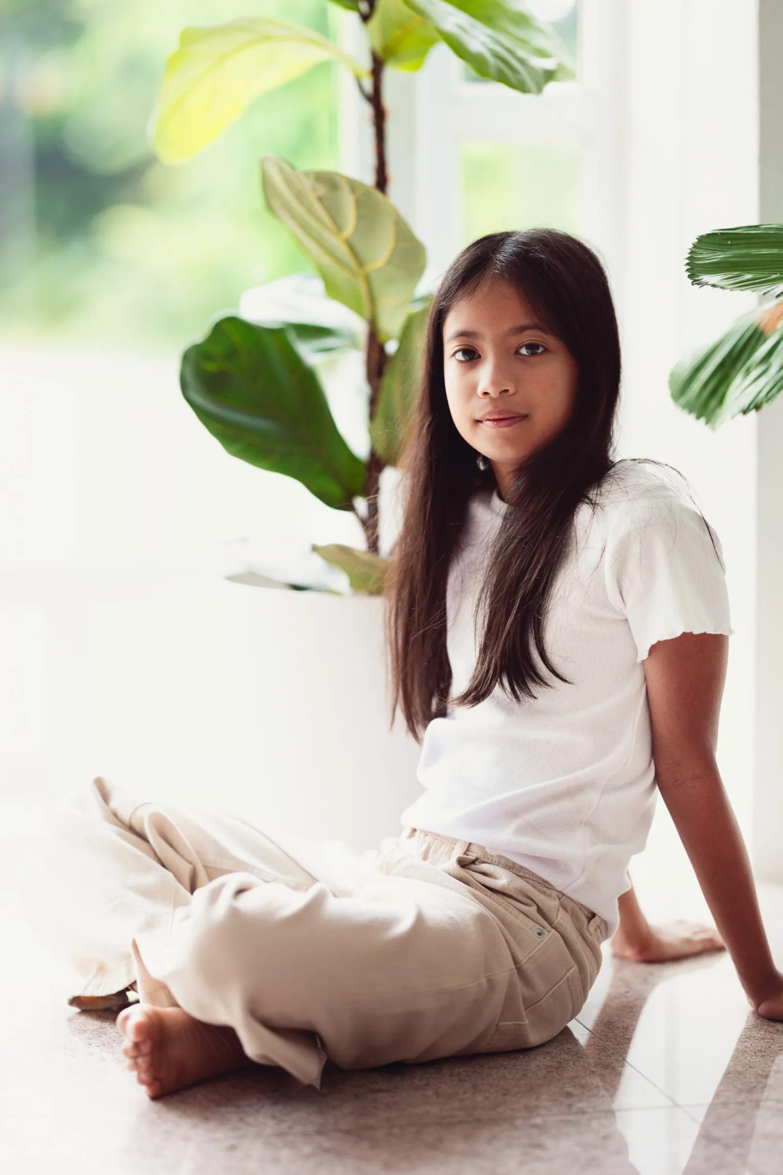 Eldest sibling reading with the younger two during relaxed indoor family session
