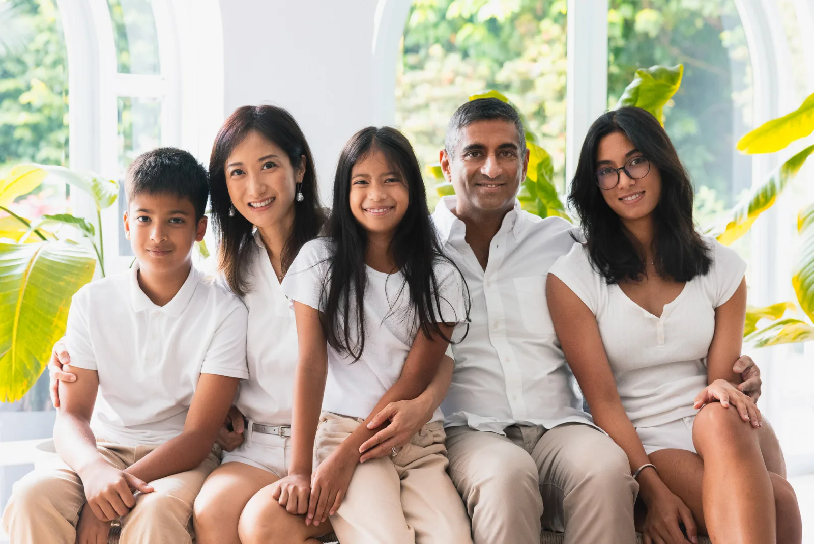 Children playing dress-up and laughing during relaxed Singapore family shoot