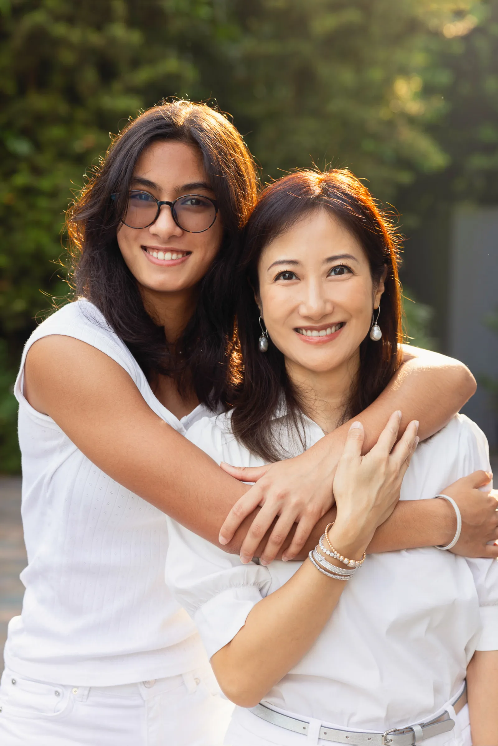 Big sister helping her younger sibling during candid family photography moment