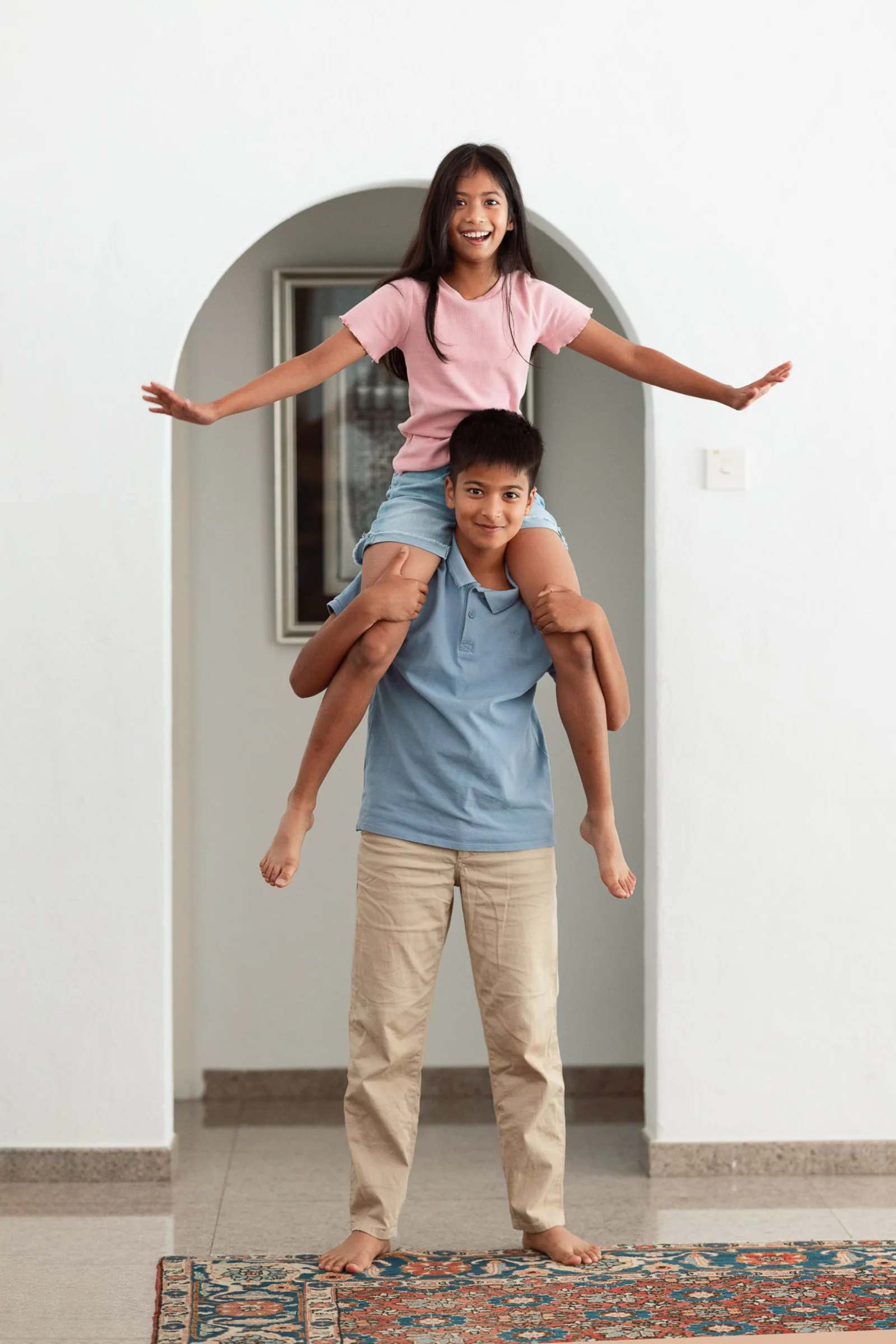 Parents sharing a quiet moment together while kids play nearby during indoor session