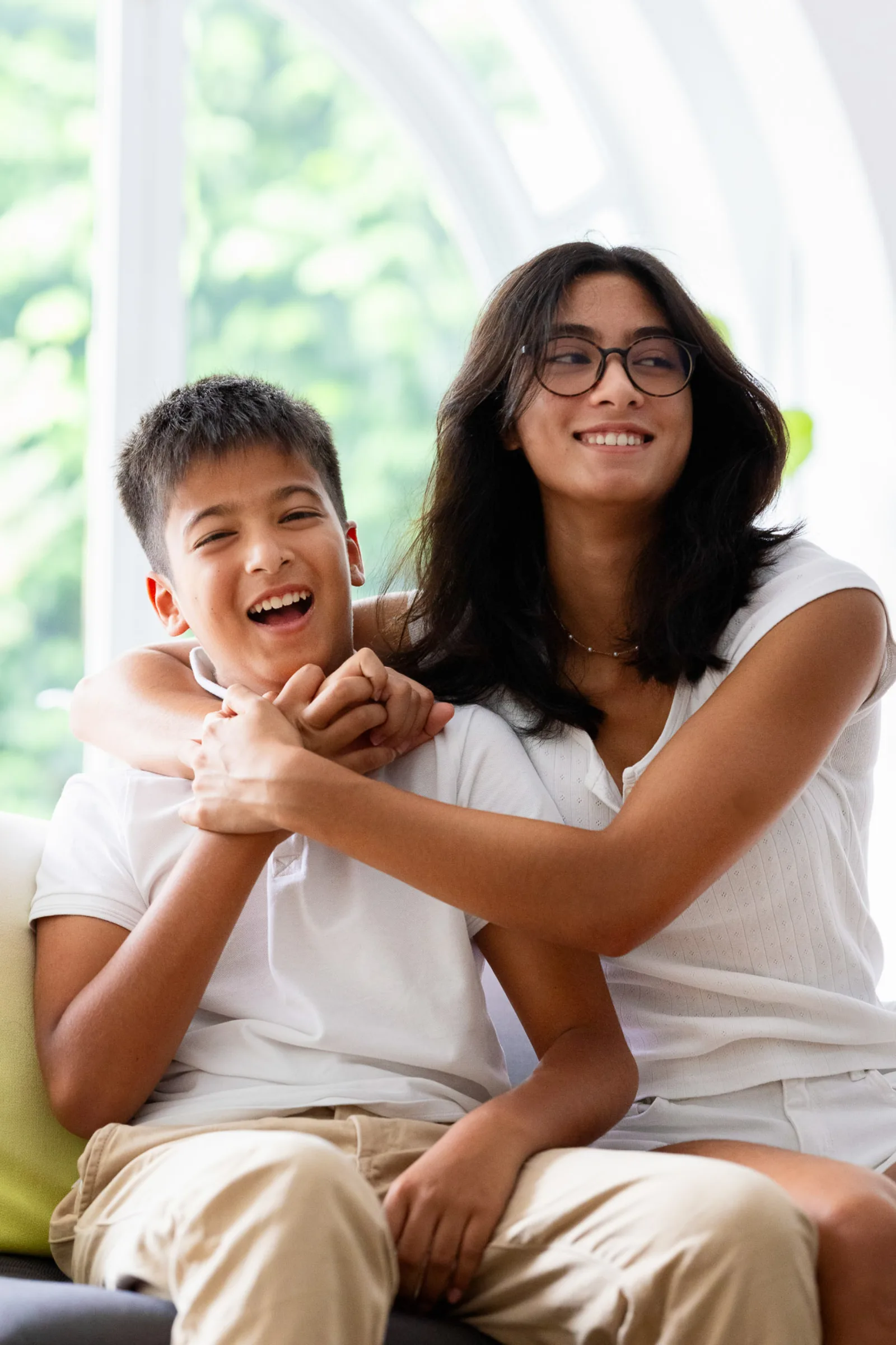 Family of five in matching white outfits during indoor photography session