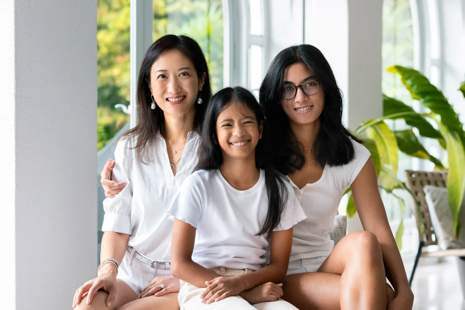 Three siblings posing together during indoor family photoshoot in Singapore
