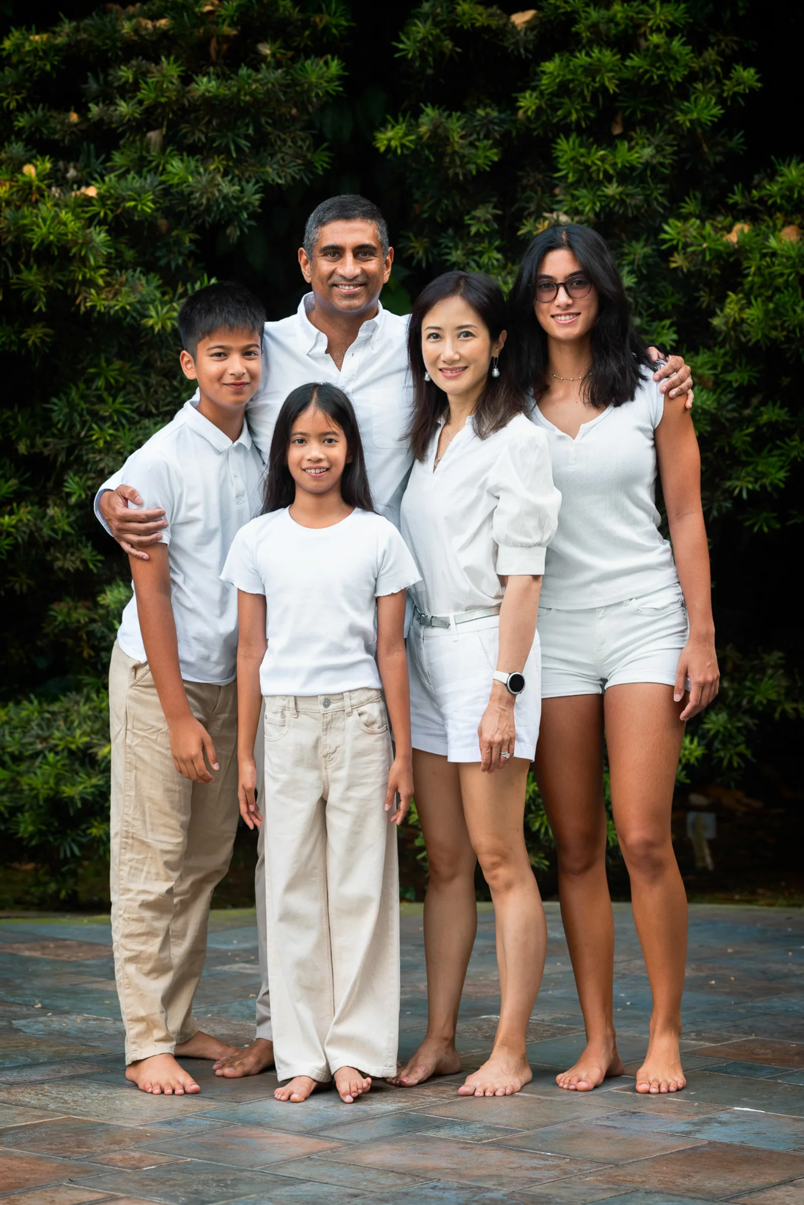 Couple portrait in white shirts with soft indoor lighting during Singapore family session