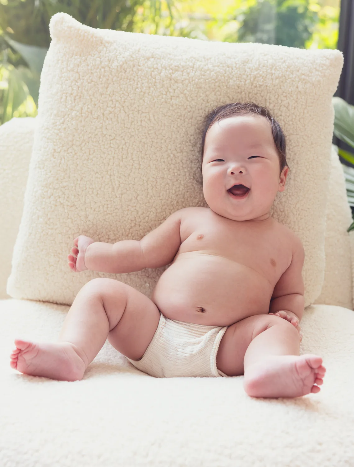 Juwon sitting on a chair during his Korean 100-day baby photoshoot