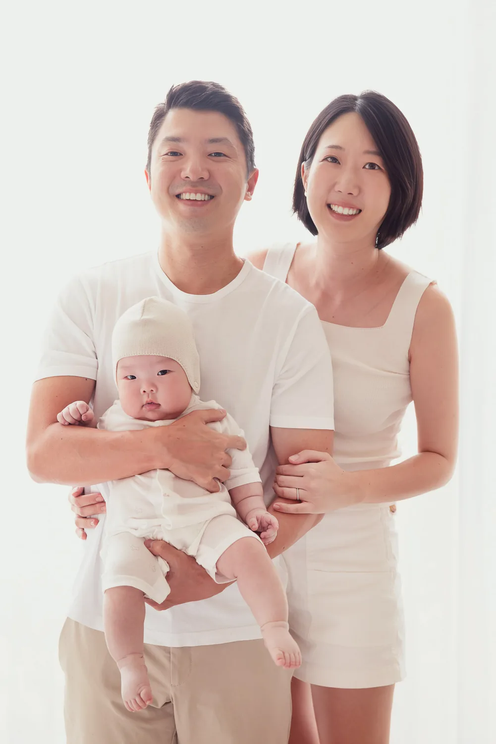 Ji, Kristin and Juwon standing together for a family portrait in Singapore