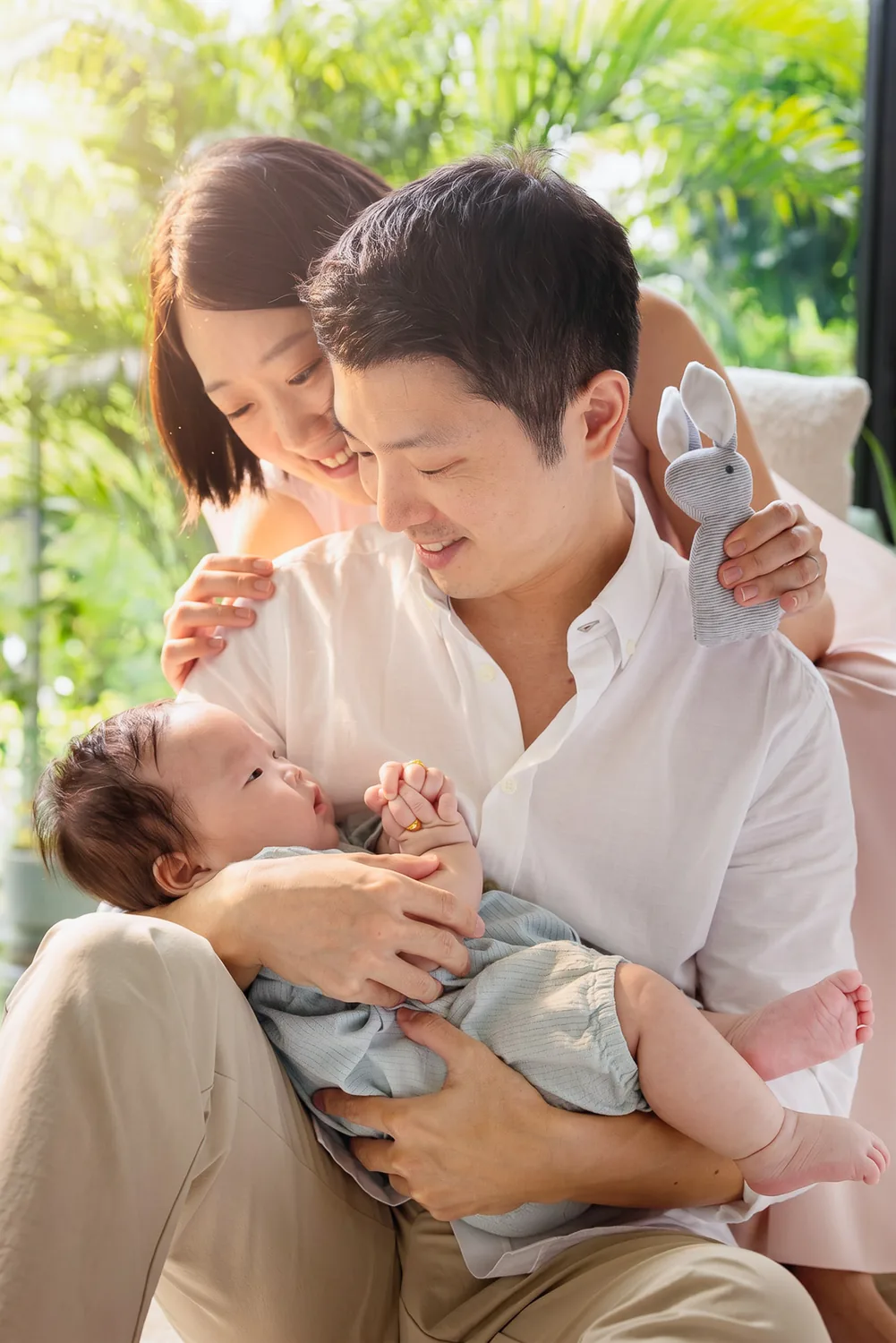 Ji and Kristin holding Juwon close during their at-home family photoshoot in Singapore