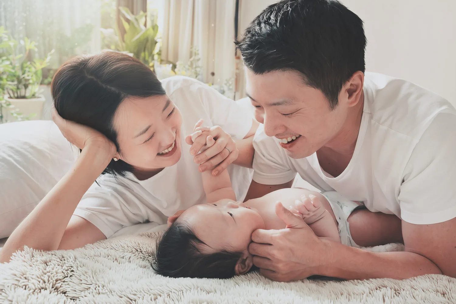 Ji and Kristin playing with Juwon during their 100-day family photoshoot at home