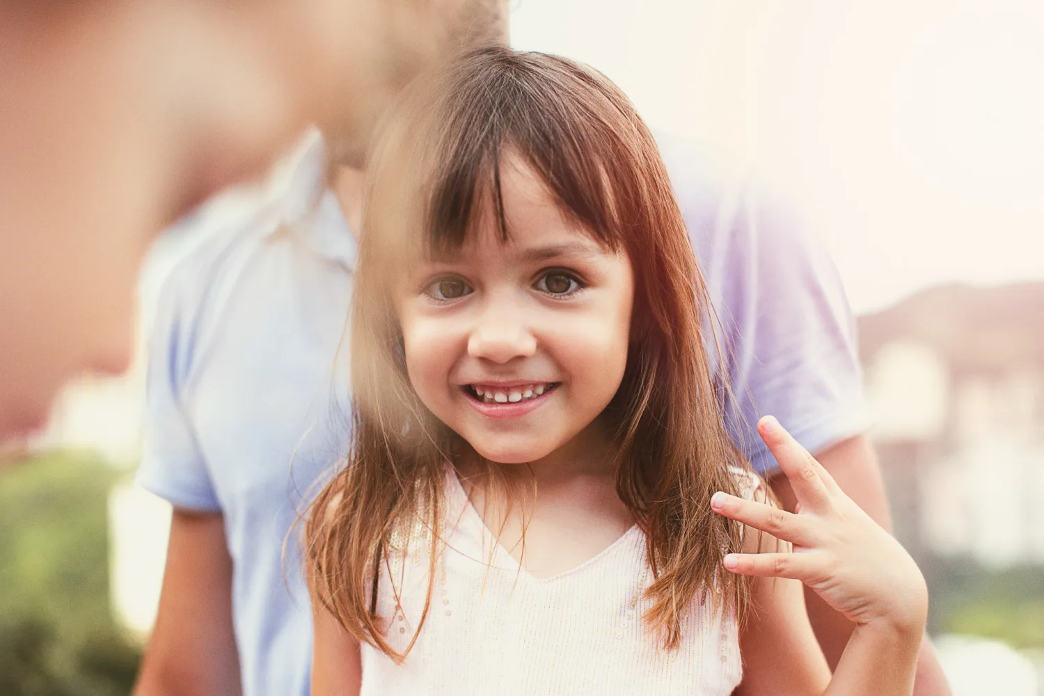 Laurence and Alex with their three daughters sitting together on the rock slab in Hong Kong