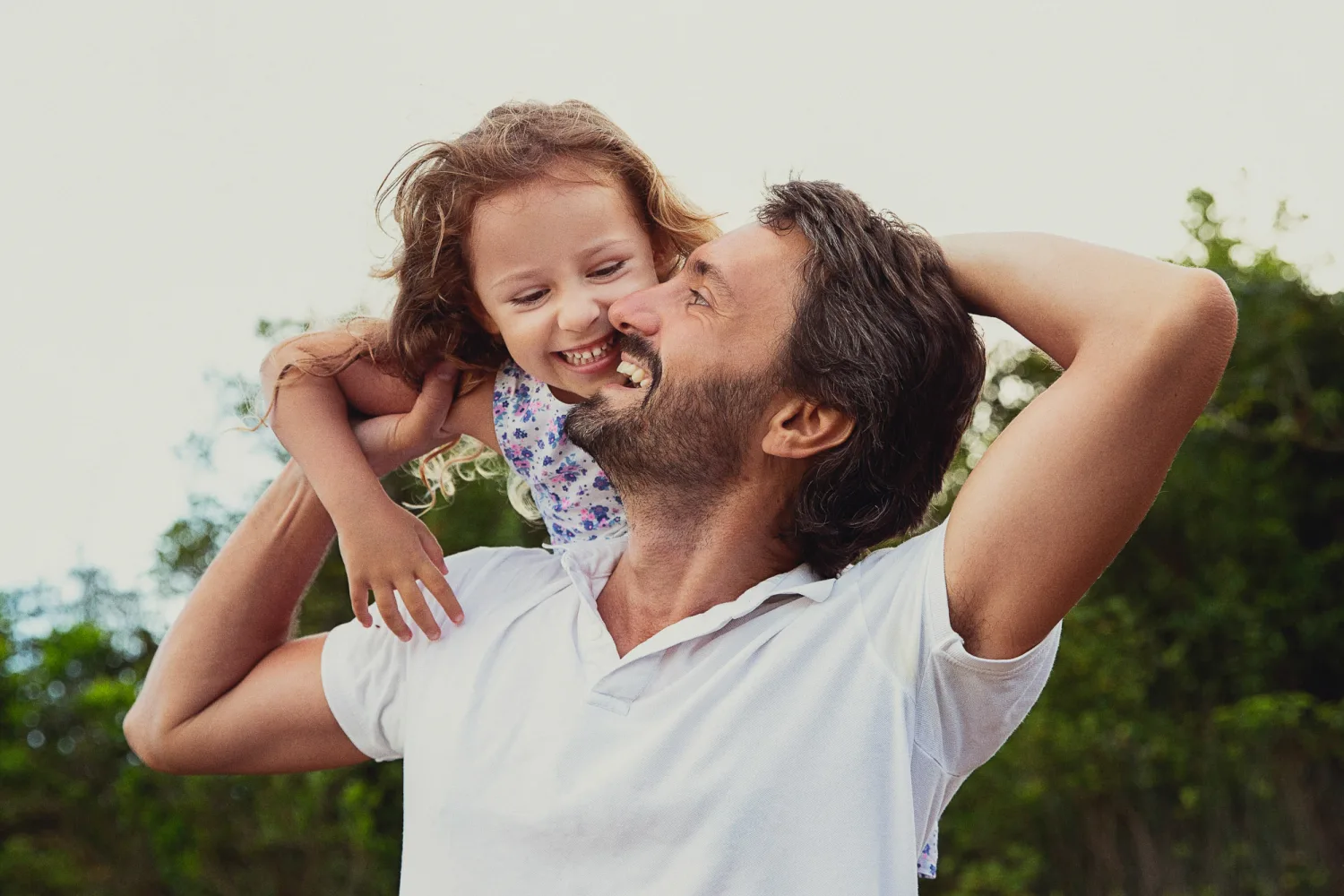 Laurence and Alex with their daughters on the rock slab clearing during the Hong Kong family session