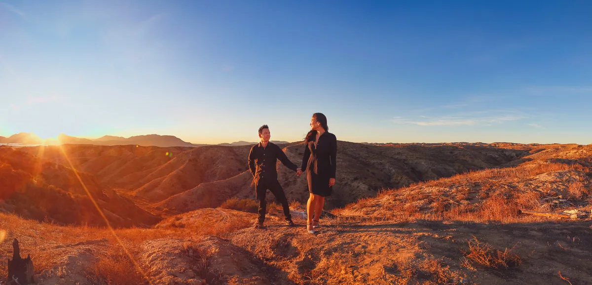 Julie and James backlit by the setting sun in Joshua Tree