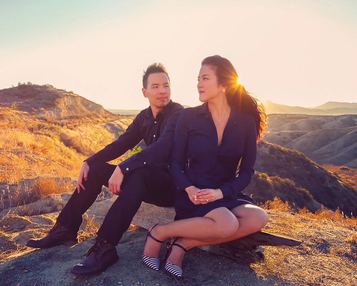 Julie and James sitting together in the desert light at Joshua Tree