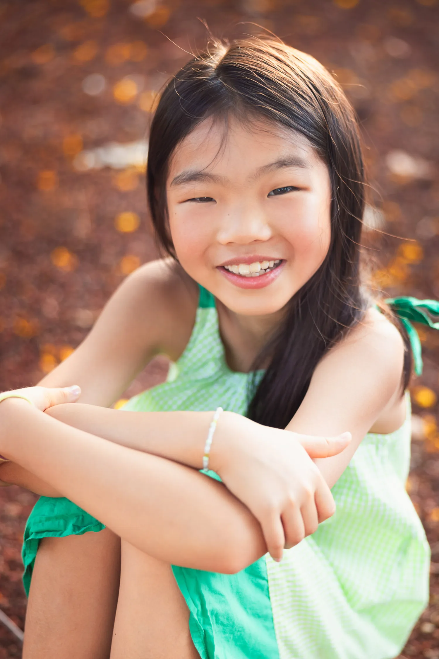 Mirei beaming at the camera with warm golden bokeh behind her in a Singapore park