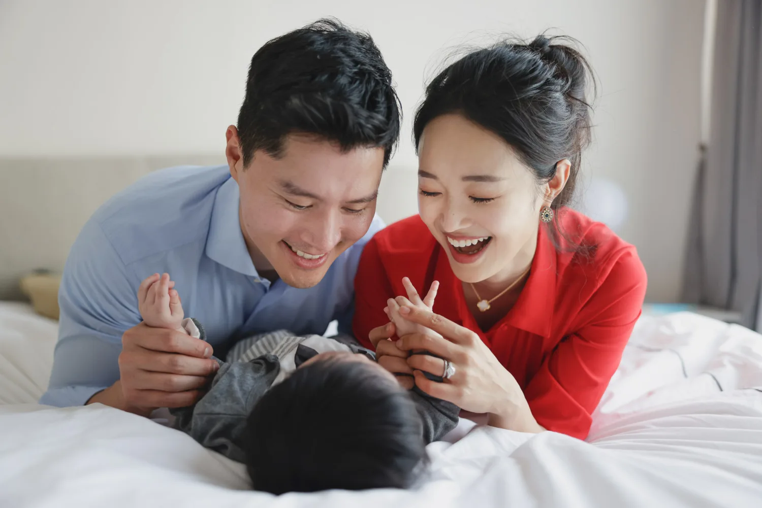 Happy family moment as Paul and Danbi smile with their newborn at home
