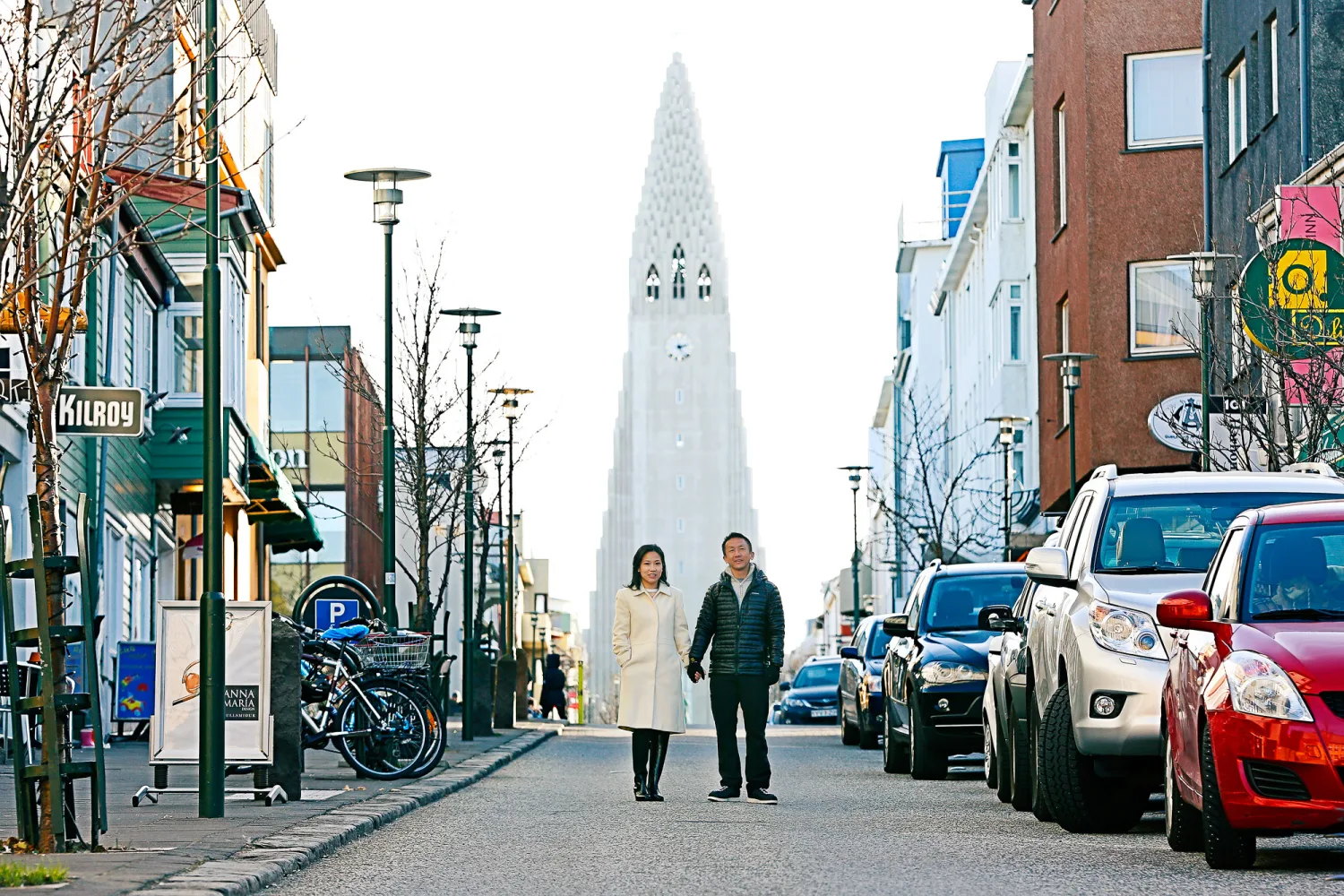 Desiree and Derek sitting beneath the Sun Voyager sculpture in Reykjavik