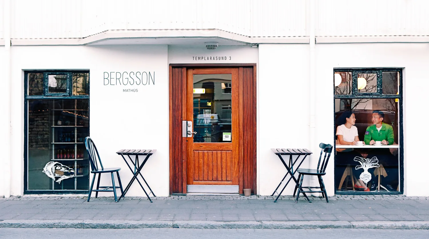 Desiree and Derek framed beneath the Sun Voyager with Reykjavik behind them