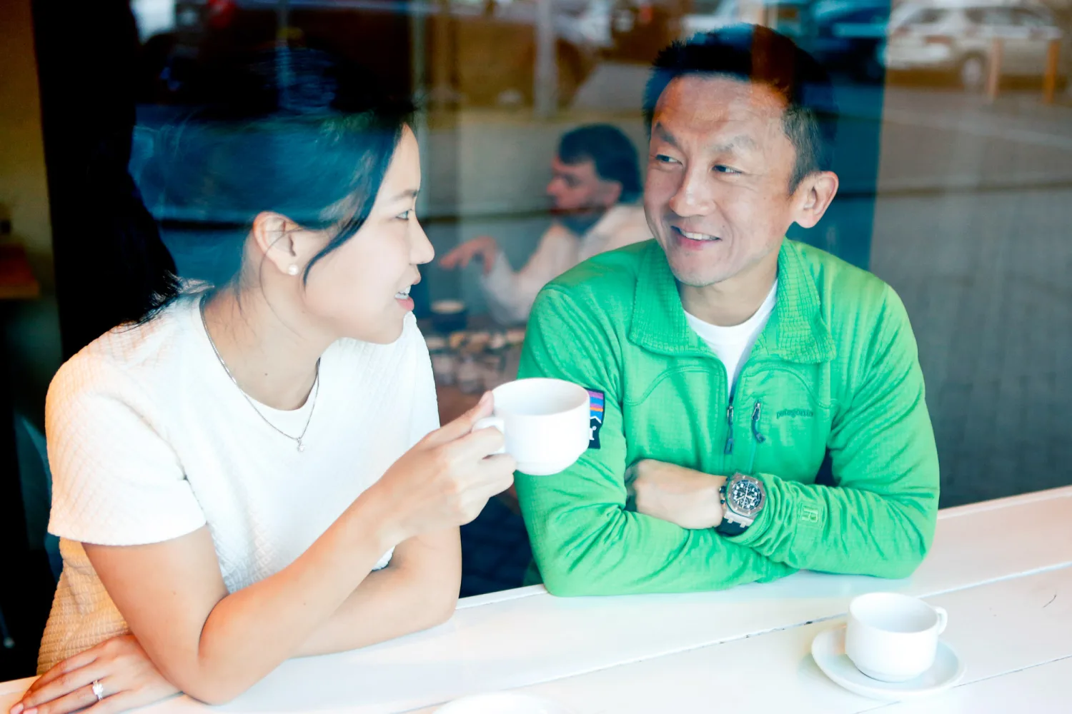 Desiree and Derek sharing coffee and conversation by the window in Reykjavik