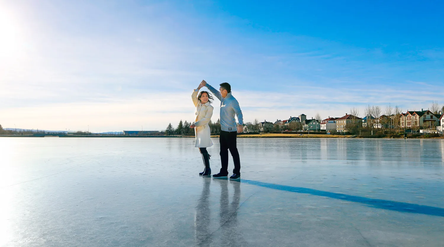 Desiree and Derek standing together on the ice during their Iceland engagement shoot