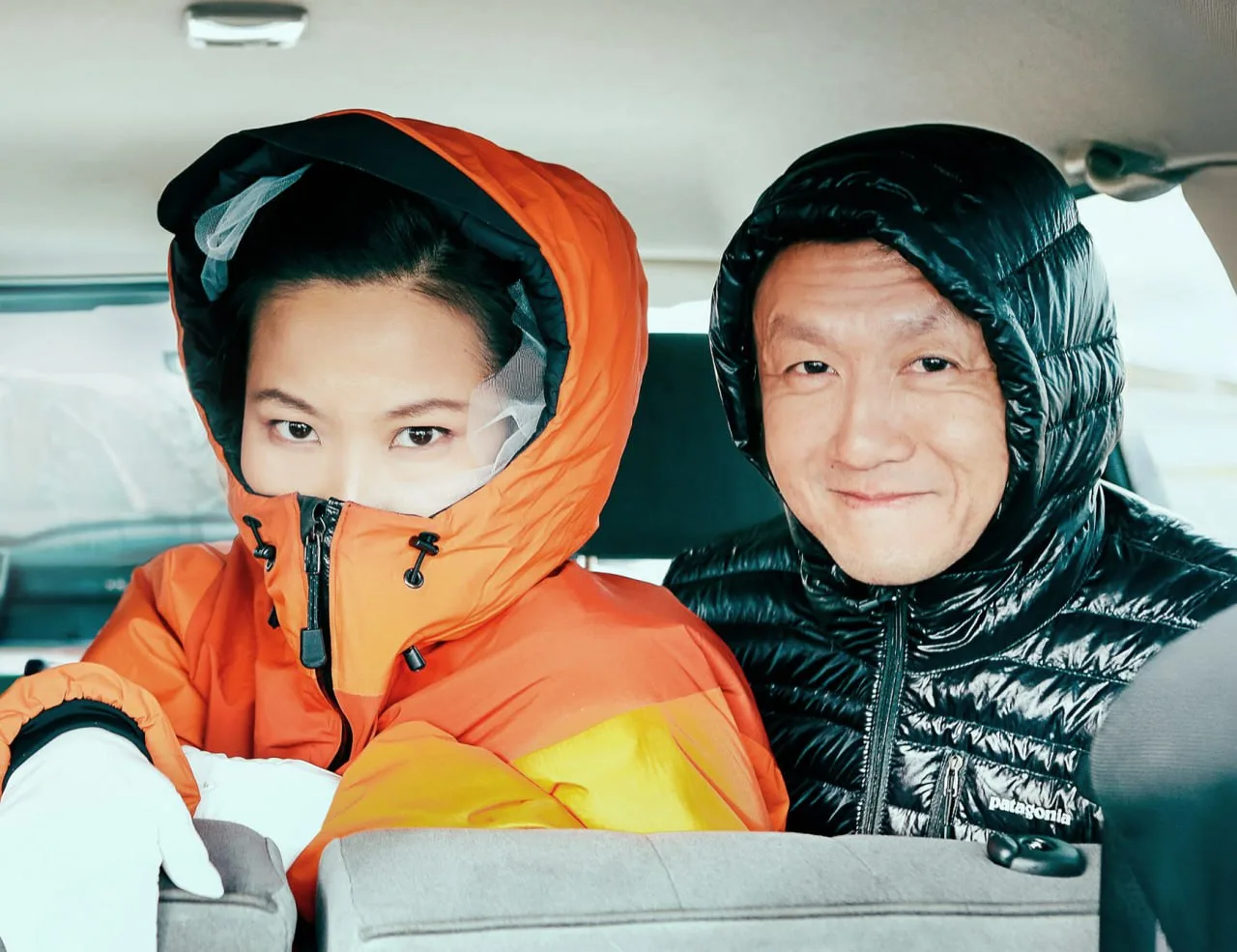 Desiree and Derek bundled up inside the car during their Iceland engagement day