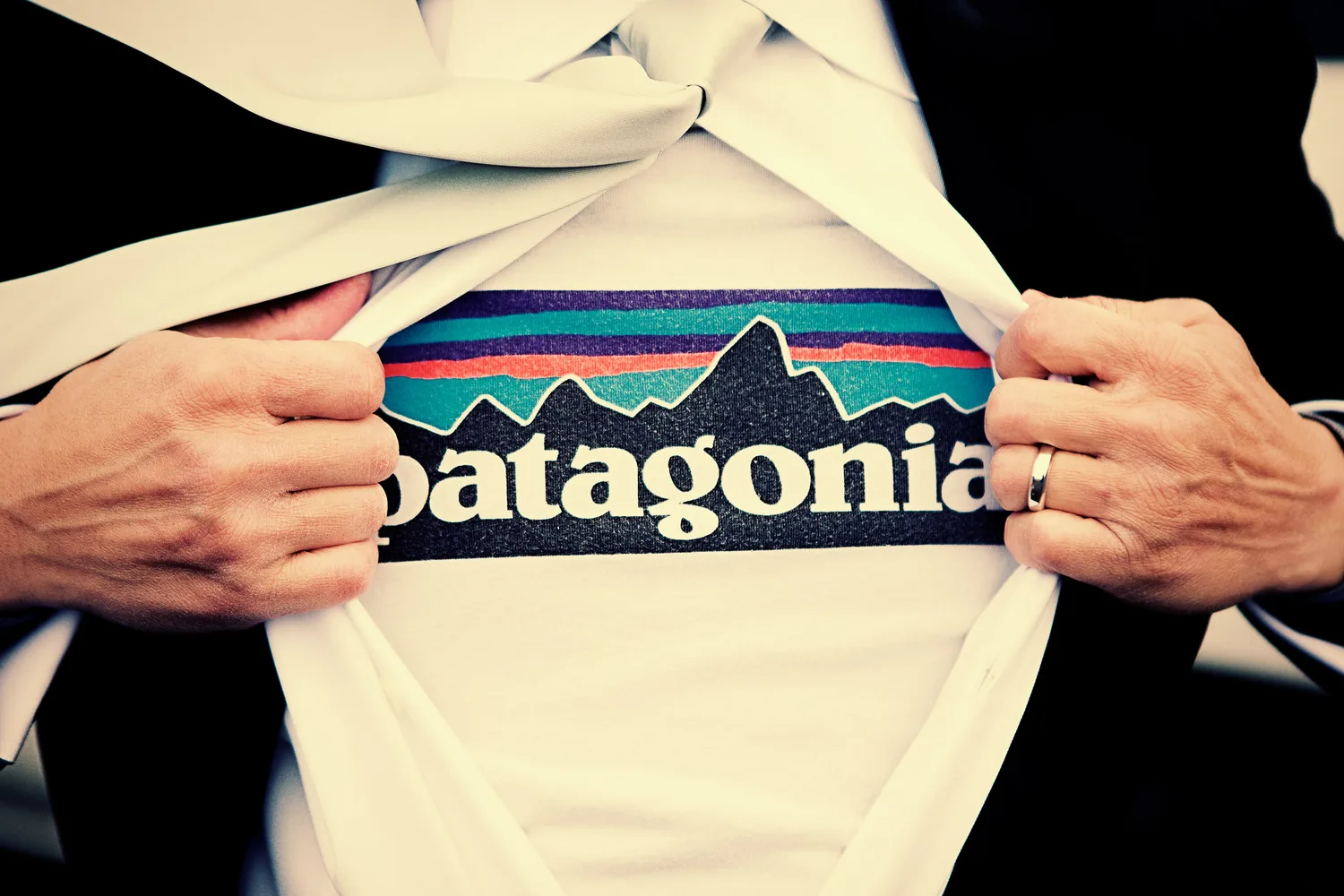 Derek pulling open his shirt to reveal a Patagonia t-shirt during the Iceland trip