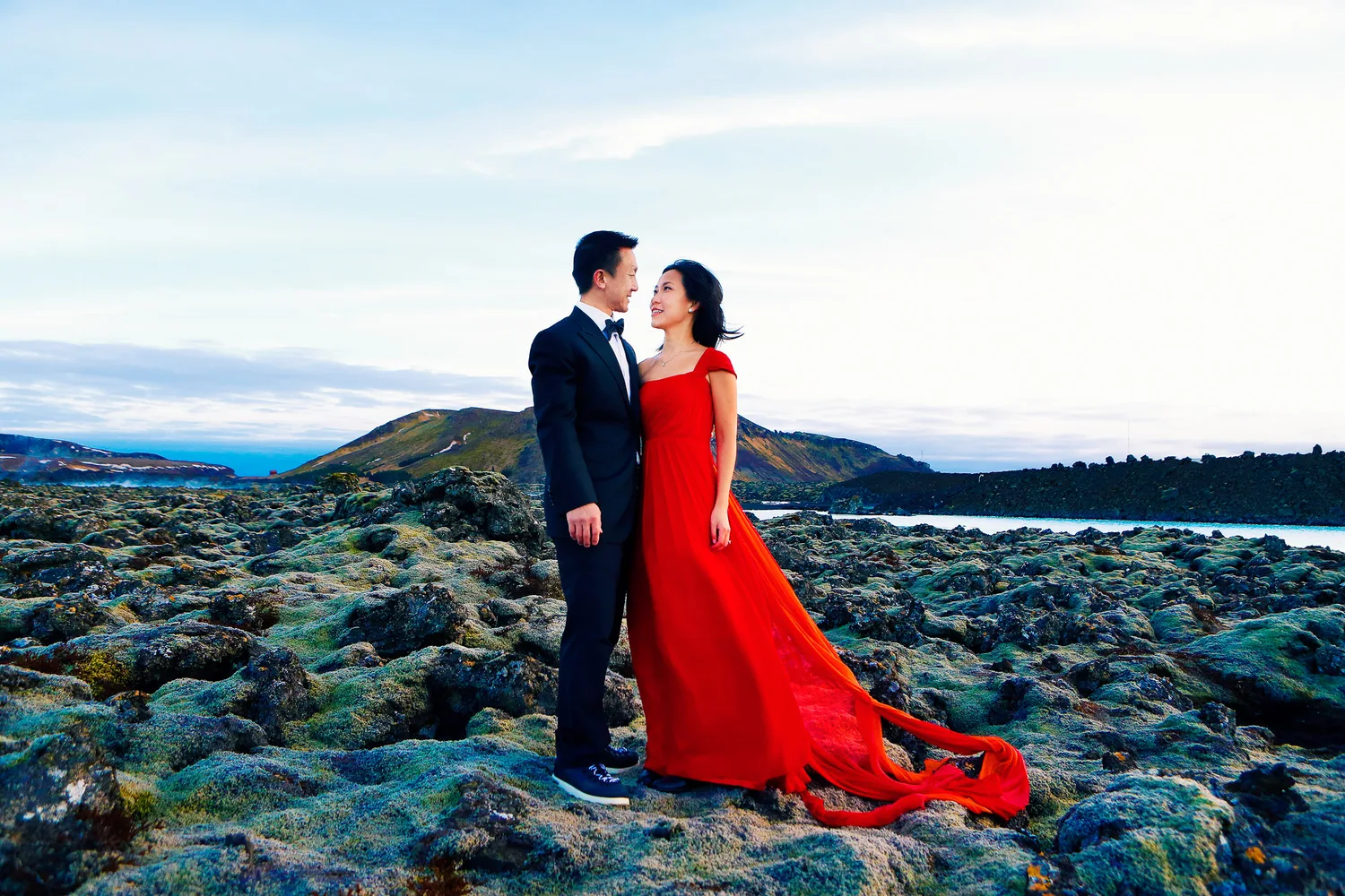 Desiree and Derek standing together in volcanic moss fields in Iceland
