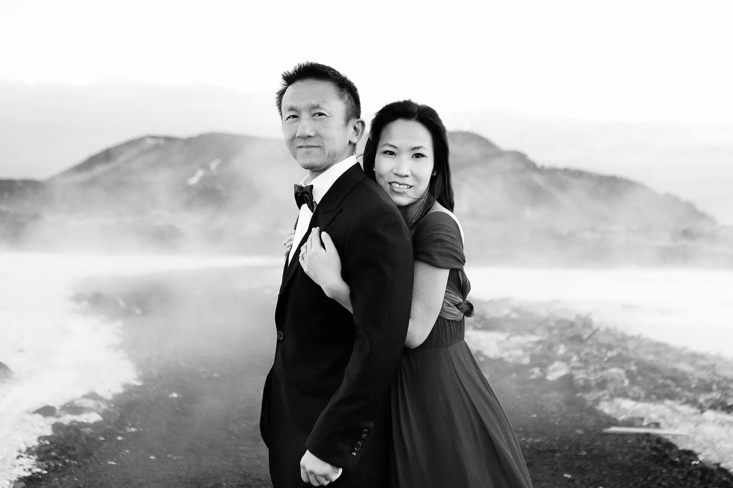 Desiree and Derek in black and white against misty Iceland terrain during their engagement shoot